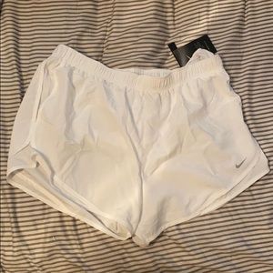 White Nike running shorts